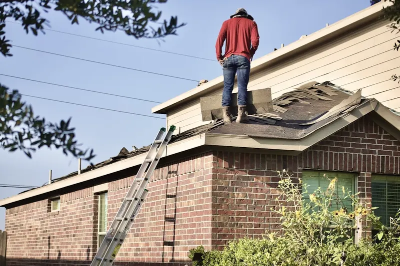 Professional roofer working on a residential roof in Sorrelhorse